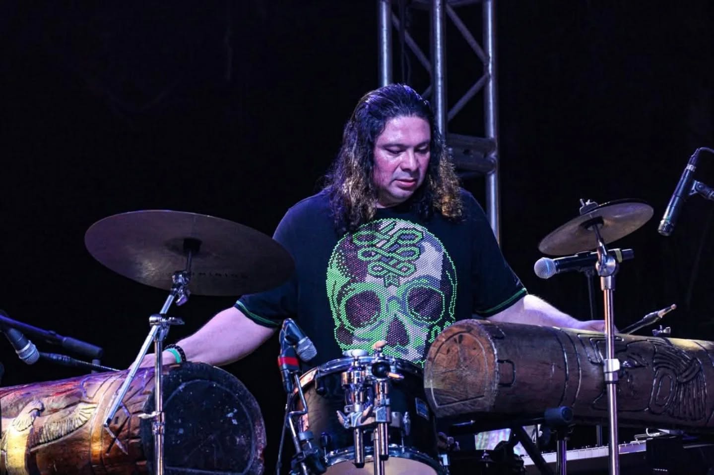 Cris Alcocer performing with percussion instruments from the Mayab